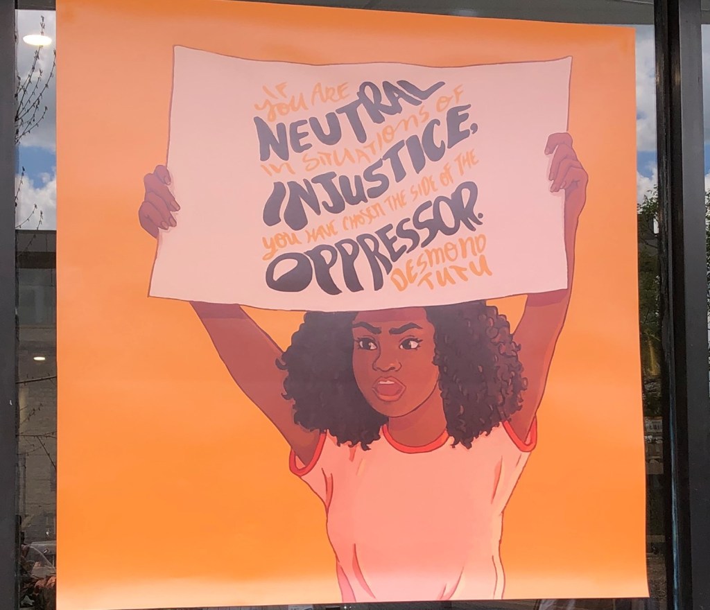 "If you are neutral in situations of injustice, you have chosen the side of the oppressor." Desmond Tutu. Sign in the window of a cheese shop in Carden Street, Guelph, Ontario.